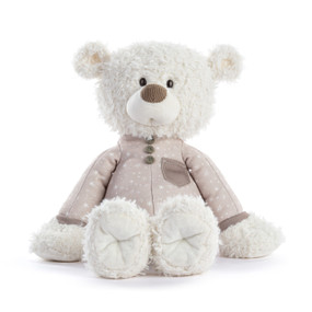 A white teddy bear wearing a light brown pair of pajamas.