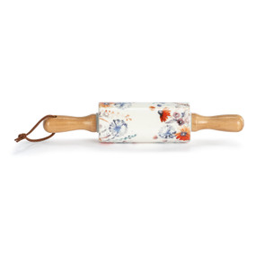A small white decorative ceramic rolling pin with wood handles and a wildflower illustration on the roller.