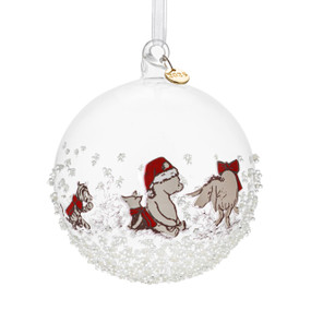 A clear round ornament with images of Winnie the Pooh and friends. The ornament has small beads and a metal tag at the top with "2025".