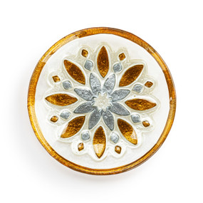 A mini round glass plate with a gold and silver snowflake and a gold rim.
