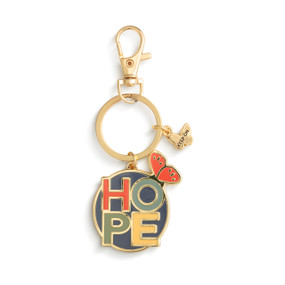 A gold keychain with two charms. One is a small gold butterfly and the other is a circle with a butterfly and has the saying "Hope".