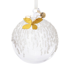A clear round glass ornament with small white beads and a gold metal butterfly at the top. There is also a round metal tag with 2025.
