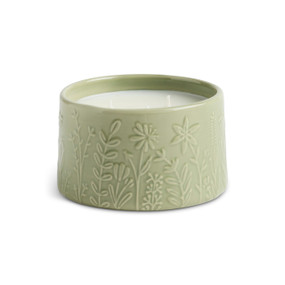 A three wick mint citronella candle in a light green ceramic container with botanical images around it.