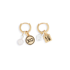 A pair of gold hoop earrings with four different charms related to love.