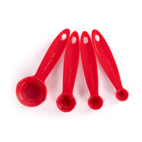 A set of four red melamine measuring spoons.