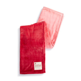 A red ombre blanket with a cream fabric patch with the saying "You Can't be Sleeping on Christmas!" displayed folded over itself.