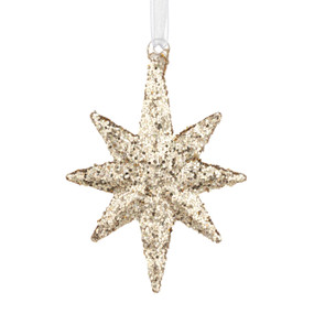 A small gold star shaped ornament decorated with gold glitter.