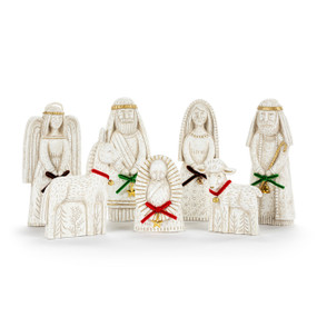 A seven piece white paper pulp nativity scene with red or green ribbons and gold charms on each figure.