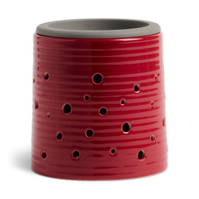 A round red ceramic wax melter with a gray silicone dish.