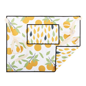 An orange and white half apron with a citrus pattern on the front along with a pocket and cream ties.