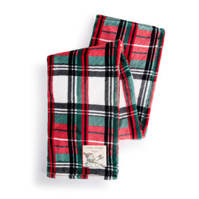 A red, green and black plaid blanket with a fabric patch in the corner with a snowman and the saying "cozy winter days" displayed folded over itself.