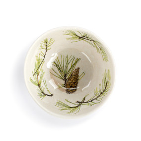 Top down view of a white dip bowl with illustrated pine branches and a pinecone inside.