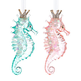 A set of two Seahorse shaped ornaments. One is pink and the other blue and they are both decorated with silver sparkle and beads.