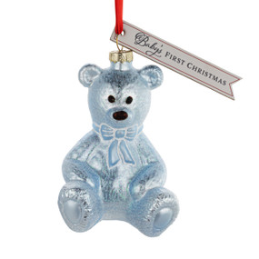 A blue teddy bear shaped ornament with a tag that says "Baby's First Christmas".