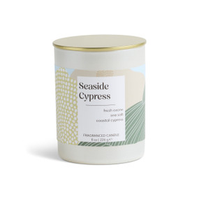 An 8 oz seaside cypress scented candle in a round white container with a gold lid.