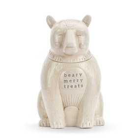 A cream ceramic cookie jar in the shape of a sitting polar bear. The saying "beary merry treats" is on the front.