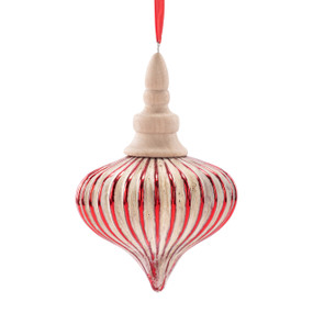 A wood carved ornament shaped like a ribbed onion with red on the outer edges.
