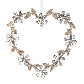 A heart shaped ornament with gold glittery leaves and flower petals of clear beads.