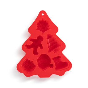 A red tree shaped silicone baking mold with different holiday shapes including a snowflake, a tree and Santa.