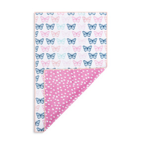 A rectangular double sided towel. One side is white with pink and blue butterflies and the other is pink with white dots, displayed with the pink corner turned back.