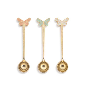 A set of three gold stir spoons each with a different pastel butterfly at the top.