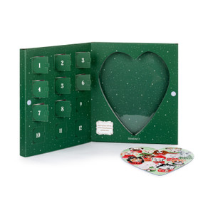 A heart shaped dogs in holiday sweaters themed puzzle where the pieces are inside 12 countdown holes in a green box.