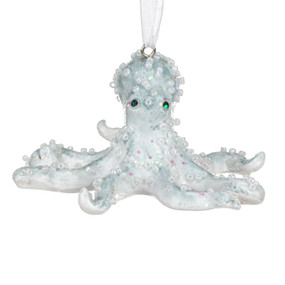 A light blue octopus shaped ornament decorated with white beads.