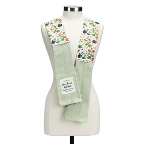 A white fabric kitchen boa with a floral illustration and light green towel ends. There is a patch that says "Grandma's Kitchen made with love".