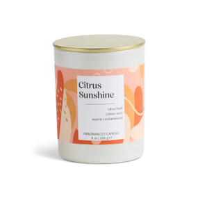An 8 oz citrus sunshine scented candle in a round white container with a gold lid.