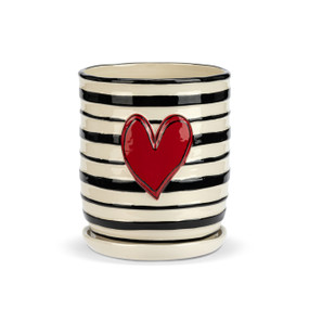 A black and white striped ceramic planter with a white saucer and a red raised heart on the front.