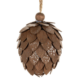 A large pinecone shaped ornament made with brown wood chips and dusted with silver sparkle.