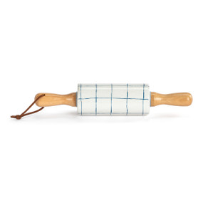 A small white decorative ceramic rolling pin with wood handles and thin blue plaid lines on the roller.