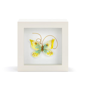 A yellow and green butterfly with gold wire tentacles in a white shadow box.