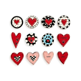 A set of round and heart shaped ceramic magnets in red, black and pink.