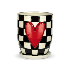 A black and white check ceramic planter with a white saucer and a red raised heart on the front.