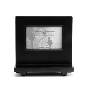 A 4x6 wood frame painted black with a shelf built in front.