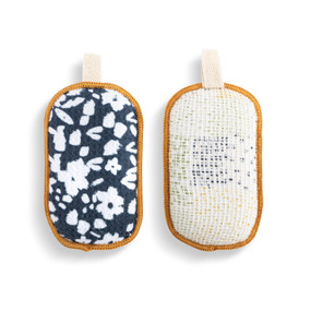 A set of two absorbent sponges with a dark blue and white floral pattern. Each has a fabric tab at the top for hanging.
