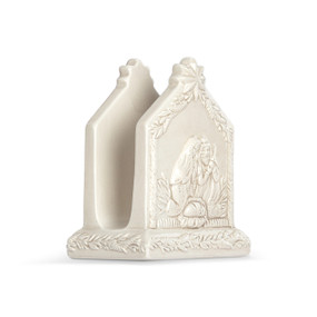 A cream ceramic napkin holder with a sculpted image of the holy family on the front.