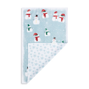 A rectangular double sided towel. One side is light blue with illustrated snowmen and the other is white with light blue snowflakes, displayed with the white corner turned back.