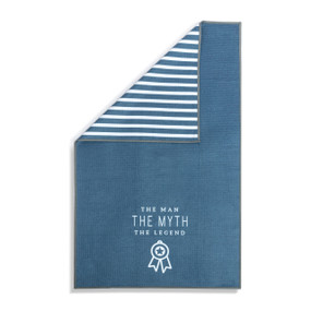 A blue and white double sided towel that has the saying "The Man The Myth The Legend". The towel is turned over at a corner showing the blue and white striped back.