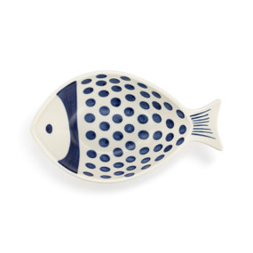 A white ceramic fish shaped dish painted with blue dots and lines.