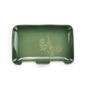 A rectangular green ceramic double spoon rest with an illustrated flower.