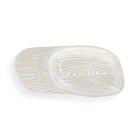 A cream ceramic spoon rest with a wood grain appearance.