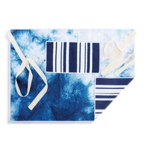 A white and blue half apron with a tie dye pattern on the front along with a pocket and cream ties.