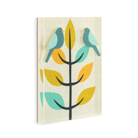 A cream acrylic wall art tile with illustrated birds on a modern leafy tree displayed angled to the right.