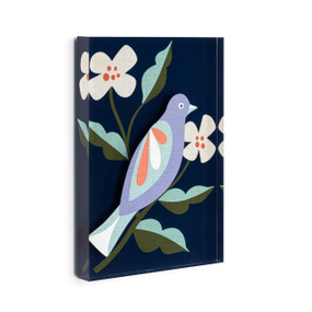 A dark blue acrylic wall art tile with an illustrated blue bird on a branch with white flowers displayed angled to the right.