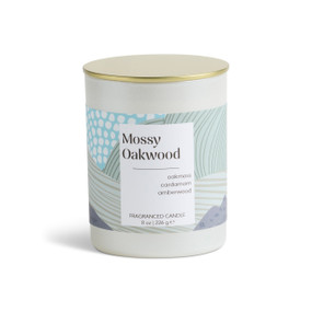 An 8 oz mossy oakwood scented candle in a round white container with a gold lid.