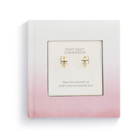 A small square pink inspirational first holy communion book with a pair of gold cross earrings inside.