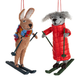 Two different felt ornaments including a rabbit and a fox. They are on skis and wearing winter gear.