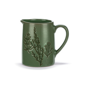 A mini dark green ceramic pitcher with a floral image on the front.